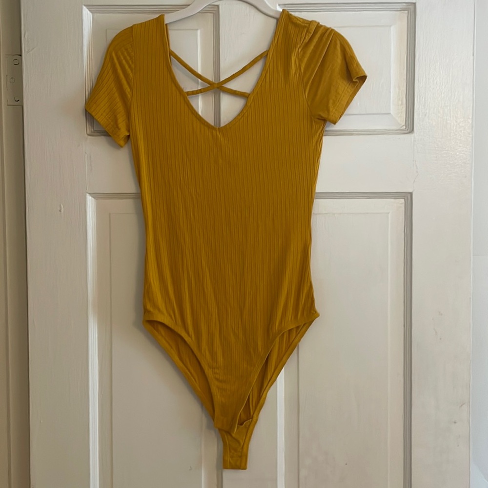 Yellow bodysuit with fun criss cross design around the neck